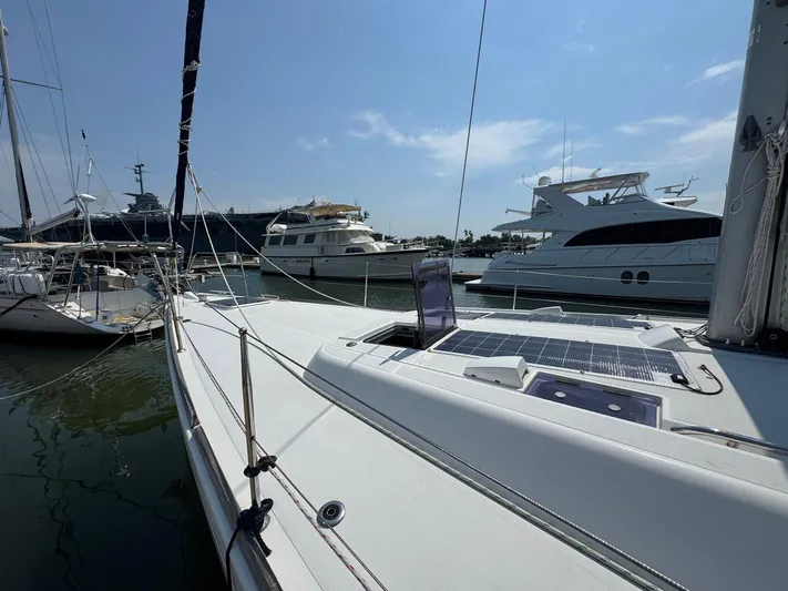 Halcyon Yacht Photos Pics 2017 Beneteau Oceanis 48 sailboat docked, featuring solar panels on deck.