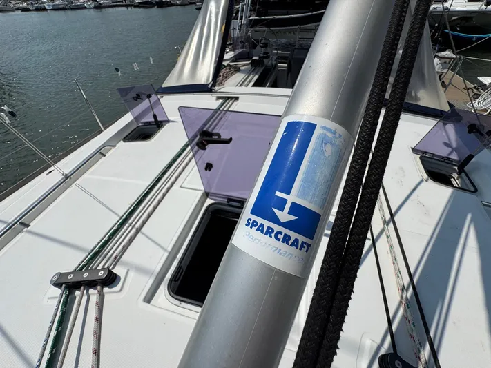 Halcyon Yacht Photos Pics 2017 Beneteau Oceanis 48 sailboat deck with Sparcraft mast, docked at marina.