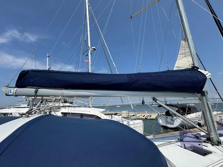 Halcyon Yacht Photos Pics 2017 Beneteau Oceanis 48 sailboat docked at marina under clear blue sky.