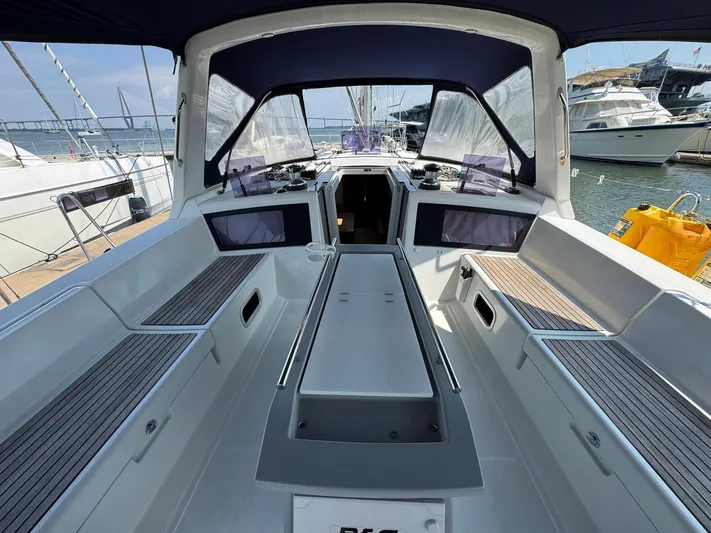 Halcyon Yacht Photos Pics 2017 Beneteau Oceanis 48 yacht cockpit with seating, docked at marina.