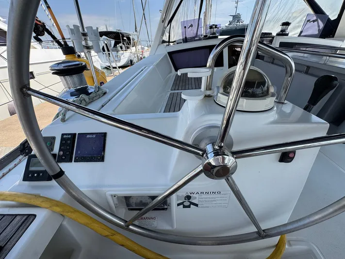 Halcyon Yacht Photos Pics Cockpit of 2017 Beneteau Oceanis 48 sailboat with steering wheel and navigation instruments.