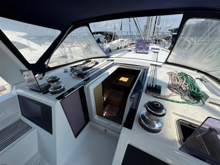 Halcyon Yacht Photos Pics 2017 Beneteau Oceanis 48 cockpit with navigation equipment and winches, showcasing modern sailing design.