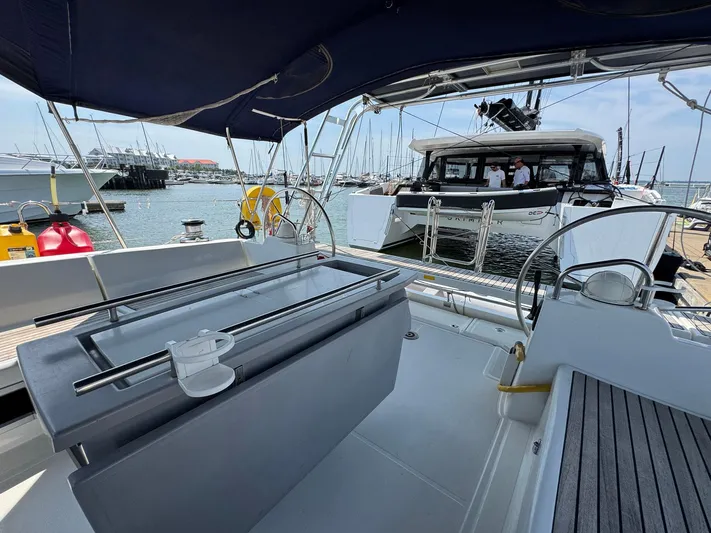 Halcyon Yacht Photos Pics 2017 Beneteau Oceanis 48 yacht interior with marina view, featuring modern helm and seating area.