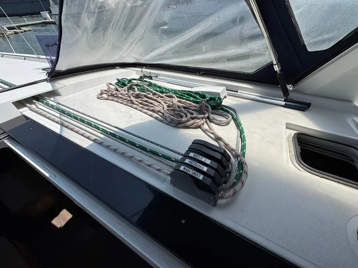 Halcyon Yacht Photos Pics Beneteau Oceanis 48 (2017) deck with ropes and winch system, showcasing sailing equipment.
