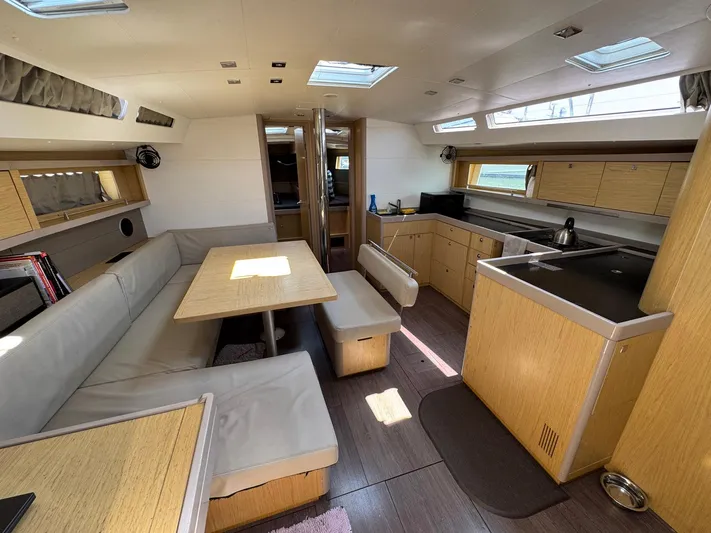 Halcyon Yacht Photos Pics Interior of 2017 Beneteau Oceanis 48 yacht with modern kitchen and seating area.