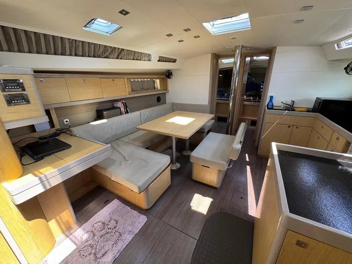 Halcyon Yacht Photos Pics Interior of 2017 Beneteau Oceanis 48 yacht with modern seating and dining area.