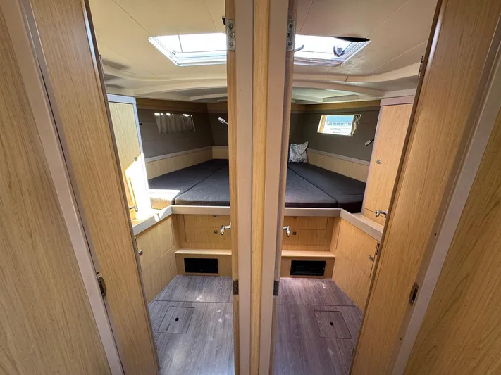 Halcyon Yacht Photos Pics Interior of 2017 Beneteau Oceanis 48 yacht, featuring a cozy cabin with wooden finishes.