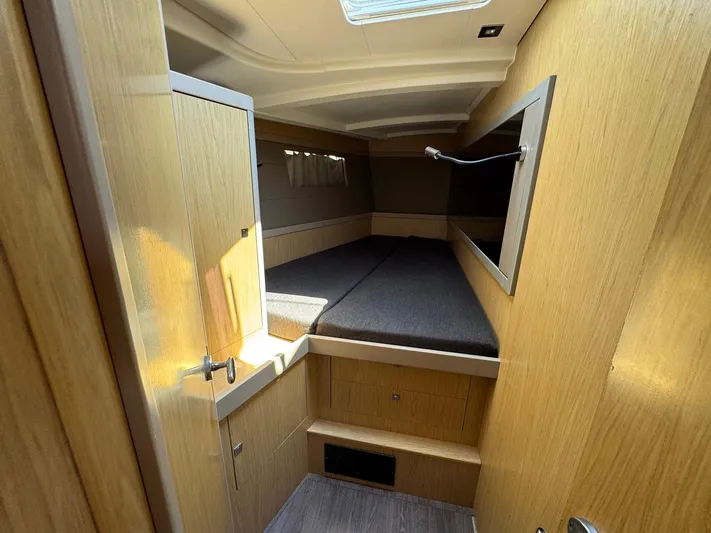 Halcyon Yacht Photos Pics Cozy cabin interior of 2017 Beneteau Oceanis 48 yacht with wooden finish.