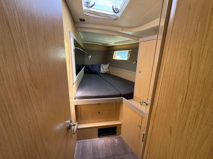 Halcyon Yacht Photos Pics 2017 Beneteau Oceanis 48 cabin interior with bed, wooden finish, and skylight.