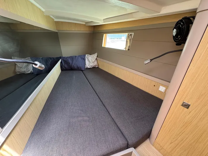 Halcyon Yacht Photos Pics 2017 Beneteau Oceanis 48 cabin interior with cozy bed and window view.