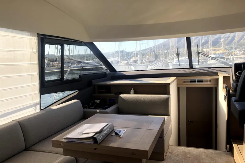  Yacht Photos Pics Interior of 2019 Prestige 590 yacht with modern seating and panoramic windows.