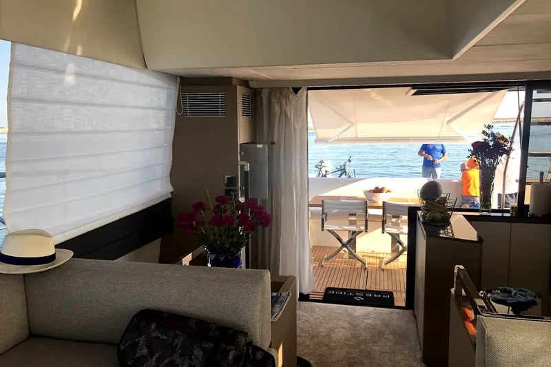  Yacht Photos Pics Luxurious interior of 2019 Prestige 590 yacht with elegant decor and scenic ocean view.