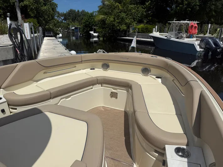  Yacht Photos Pics 2025 Chris-Craft Catalina 28 boat interior with beige seating and cup holders.