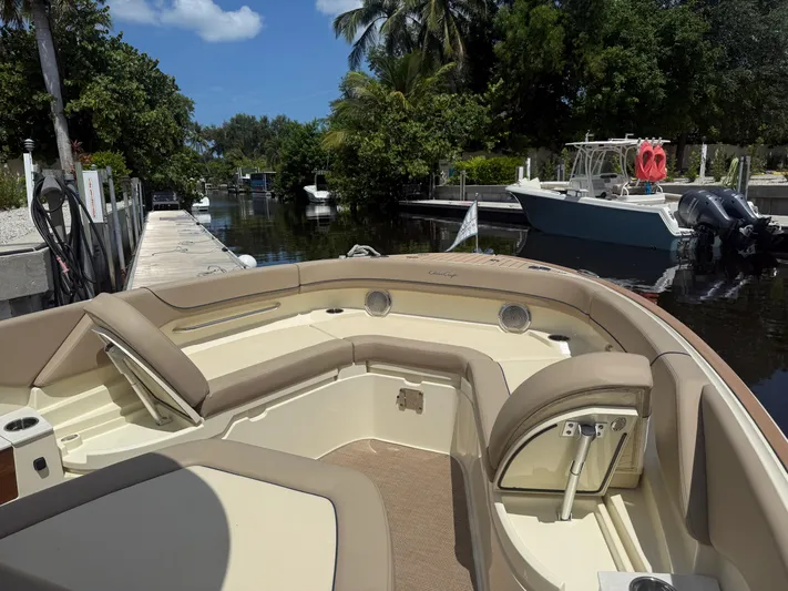  Yacht Photos Pics 2025 Chris-Craft Catalina 28 boat docked in a scenic marina with lush greenery.