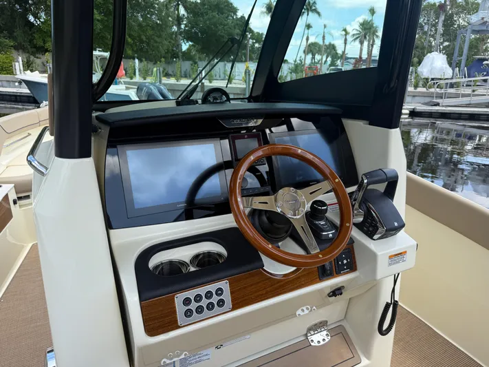  Yacht Photos Pics 2025 Chris-Craft Catalina 28 helm with modern controls and wooden steering wheel.