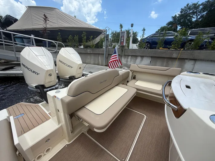  Yacht Photos Pics 2025 Chris-Craft Catalina 28 boat with twin Mercury engines, docked with seating area.