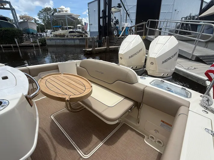  Yacht Photos Pics 2025 Chris-Craft Catalina 28 boat interior with seating, table, and twin Mercury engines.