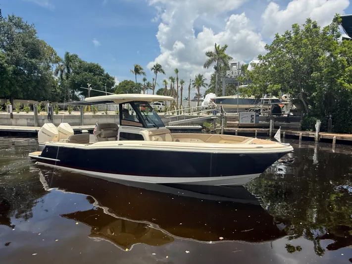  Yacht Photos Pics 2025 Chris-Craft Catalina 28 boat docked on a sunny day with palm trees in the background.