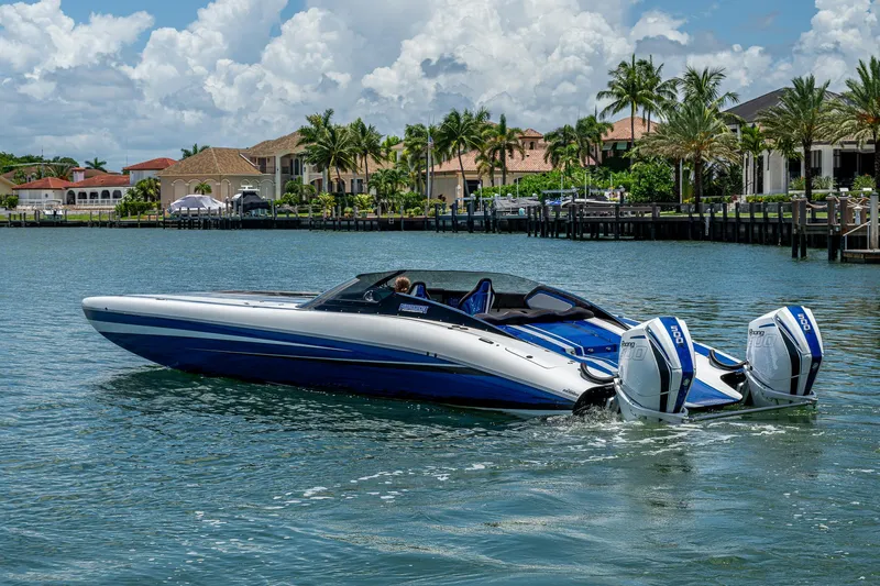  Yacht Photos Pics 2023 Performance Powerboats P360 cruising on a scenic waterfront with luxury homes.