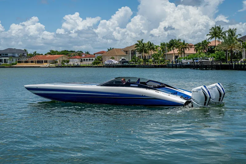  Yacht Photos Pics 2023 Performance Powerboats P360 on water, with luxury homes in the background.