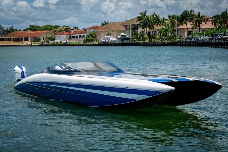  Yacht Photos Pics 2023 Performance Powerboats P360 on water, sleek design, luxury waterfront homes in background.