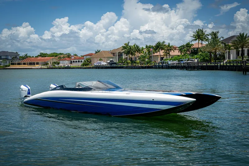  Yacht Photos Pics 2023 Performance Powerboats P360 on water, luxury waterfront homes in background.