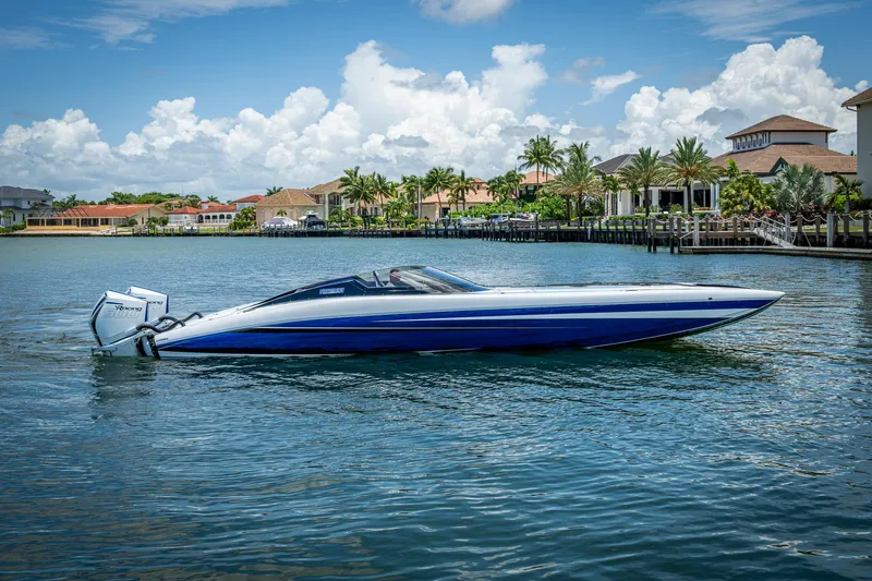  Yacht Photos Pics 2023 Performance Powerboats P360 on water, luxury waterfront homes in background.