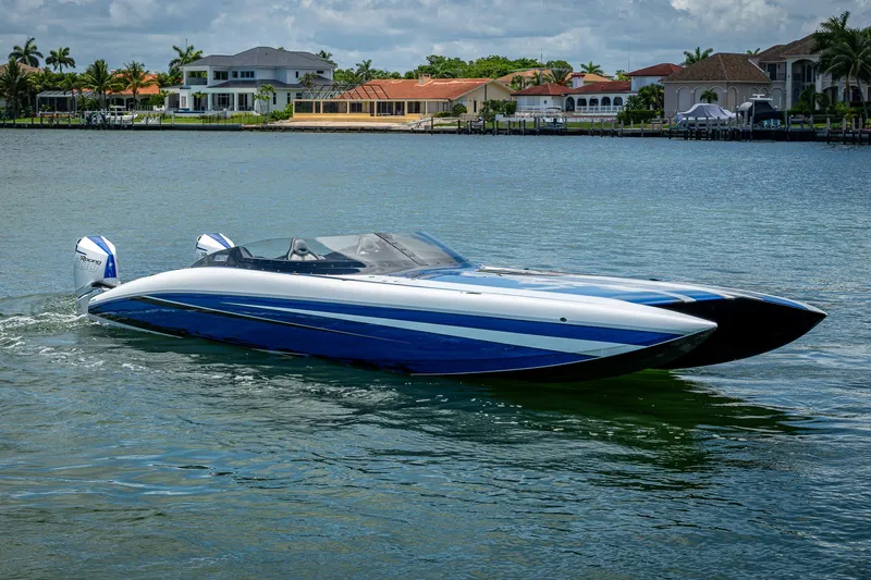  Yacht Photos Pics 2023 Performance Powerboats P360 on water, sleek design, luxury waterfront homes in background.