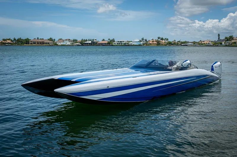  Yacht Photos Pics 2023 Performance Powerboats P360 on calm water, showcasing sleek design and vibrant blue accents.