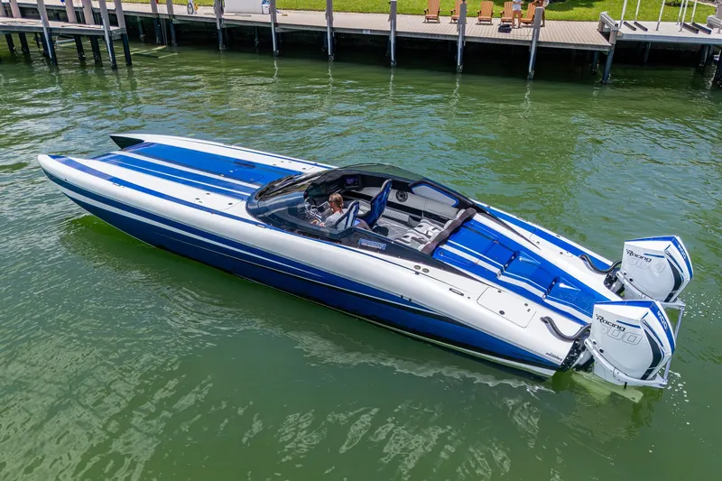  Yacht Photos Pics 2023 Performance Powerboats P360 in blue and white, docked on calm water.