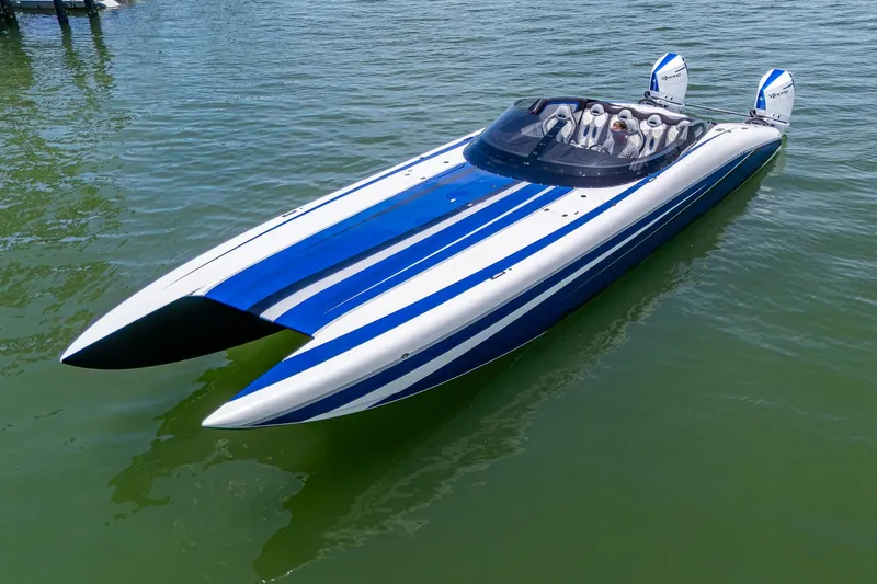  Yacht Photos Pics 2023 Performance Powerboats P360 with blue and white stripes on calm water.
