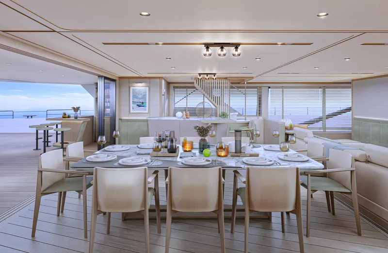 Project Polaris Yacht Photos Pics Luxurious dining area on 2026 Custom FLYBRIDGE yacht with elegant table setting and ocean view.