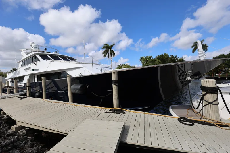 Ocean Drive Yacht Photos Pics 1988 Broward 124 Tri-Deck MY yacht docked under blue sky.