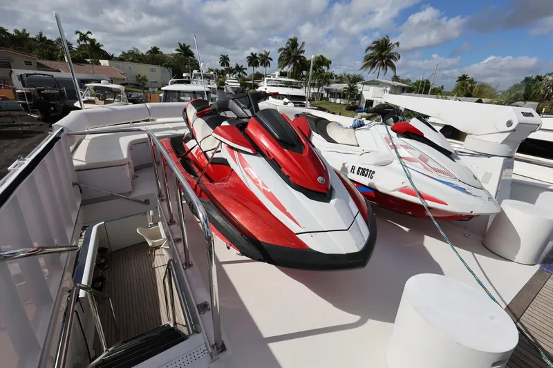Ocean Drive Yacht Photos Pics Red and white jet skis on 1988 Broward 124 Tri-Deck MY yacht deck.