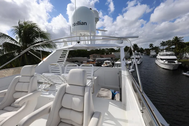 Ocean Drive Yacht Photos Pics Luxurious 1988 Broward 124 Tri-Deck yacht with plush seating on a sunny day.