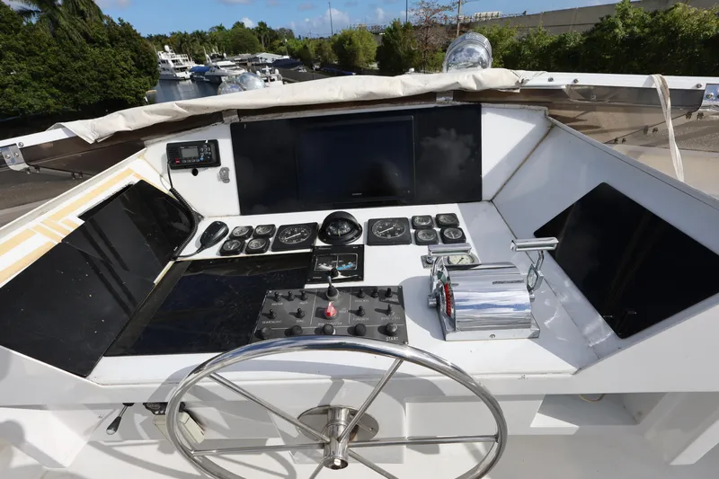 Ocean Drive Yacht Photos Pics Cockpit of 1988 Broward 124 Tri-Deck MY yacht with navigation controls and steering wheel.