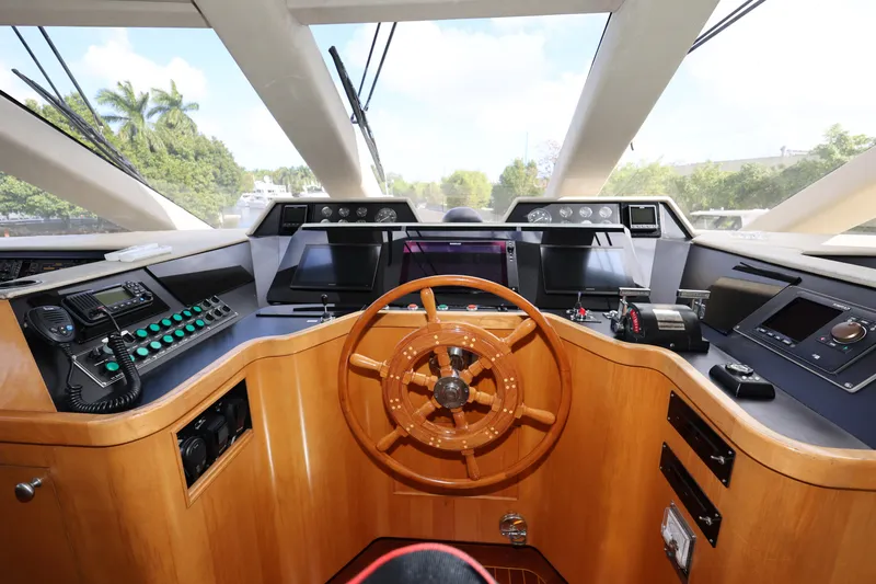 Ocean Drive Yacht Photos Pics Helm of 1988 Broward 124 Tri-Deck MY yacht with wooden steering wheel and control panels.
