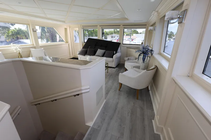 Ocean Drive Yacht Photos Pics Luxurious interior of 1988 Broward 124 Tri-Deck MY yacht with elegant seating and large windows.