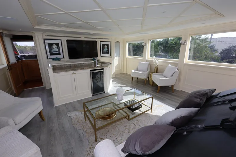 Ocean Drive Yacht Photos Pics Luxurious interior of 1988 Broward 124 Tri-Deck MY yacht with elegant seating and modern decor.