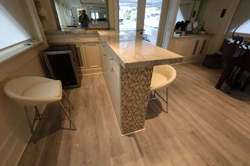 Ocean Drive Yacht Photos Pics Luxurious interior of 1988 Broward 124 Tri-Deck MY yacht with elegant seating and modern decor.