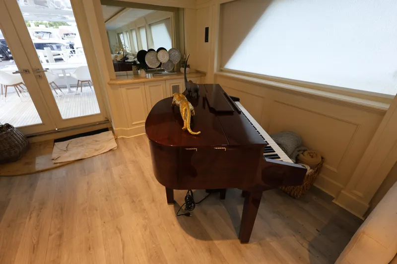 Ocean Drive Yacht Photos Pics Grand piano in luxurious 1988 Broward 124 Tri-Deck yacht interior.