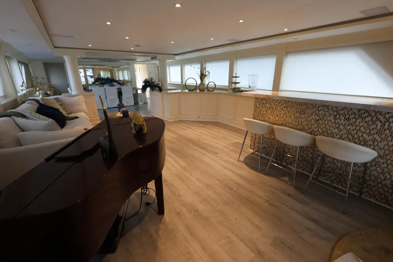 Ocean Drive Yacht Photos Pics Luxurious interior of 1988 Broward 124 Tri-Deck MY yacht with elegant decor and seating.