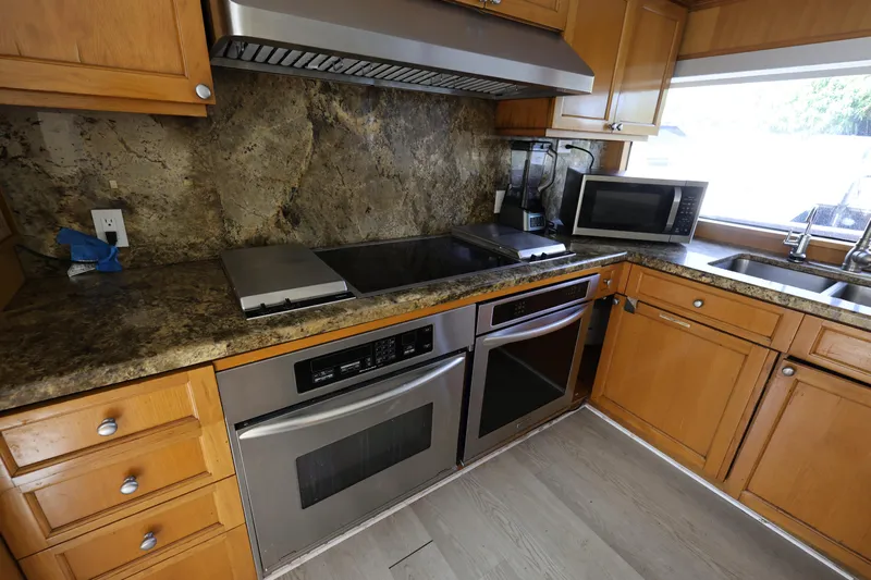 Ocean Drive Yacht Photos Pics Kitchen interior of 1988 Broward 124 Tri-Deck MY yacht with modern appliances.