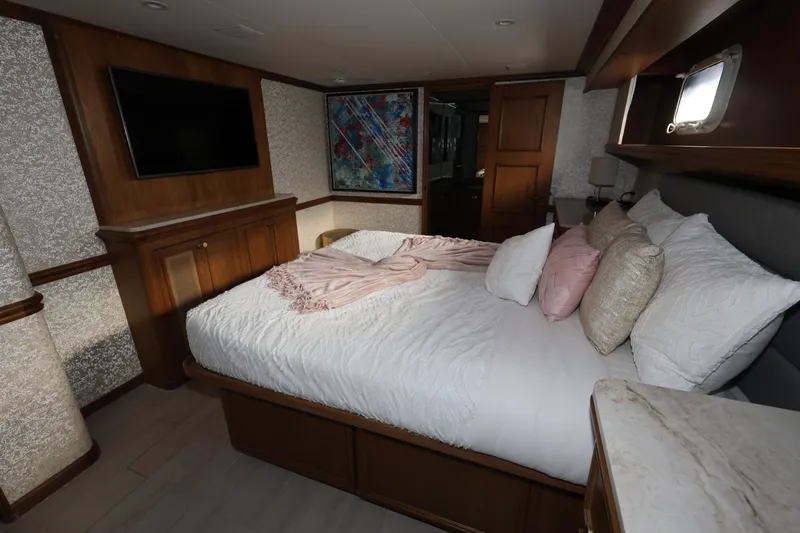 Ocean Drive Yacht Photos Pics Luxurious bedroom interior of 1988 Broward 124 Tri-Deck MY yacht with cozy bedding.