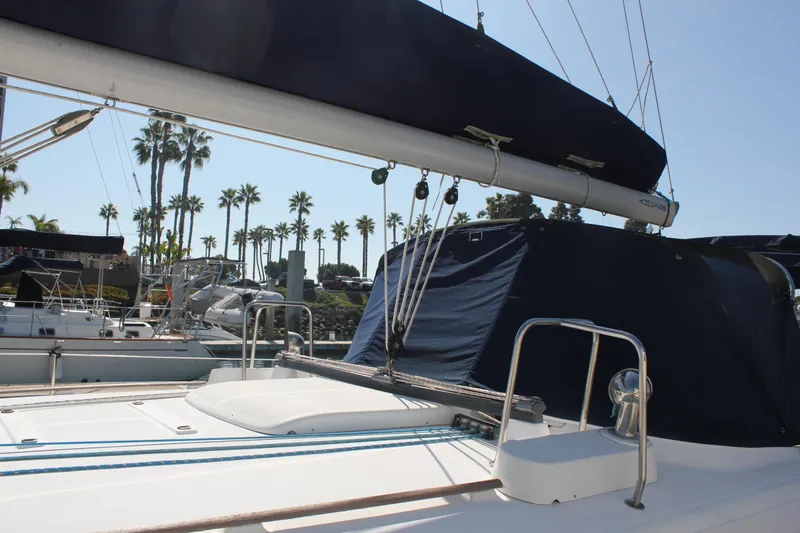 Hawaiian Passage Yacht Photos Pics 1997 Beneteau Oceanis 461 sailboat docked, featuring deck and rigging, with palm trees in background.