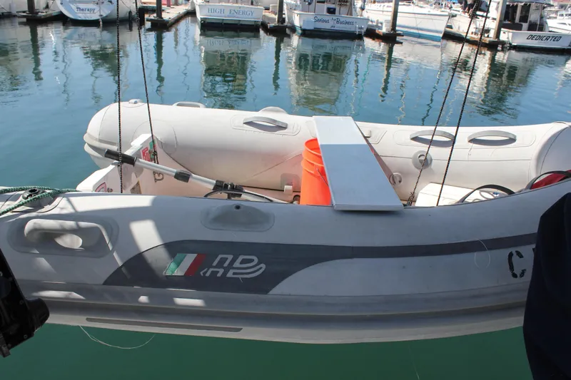 Hawaiian Passage Yacht Photos Pics Inflatable boat docked near Beneteau Oceanis 461, 1997 model, in a marina setting.