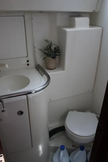 Hawaiian Passage Yacht Photos Pics Bathroom interior of 1997 Beneteau Oceanis 461 yacht, featuring sink, toilet, and storage space.