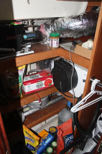 Hawaiian Passage Yacht Photos Pics Storage area inside a 1997 Beneteau Oceanis 461 sailboat with various supplies and equipment.