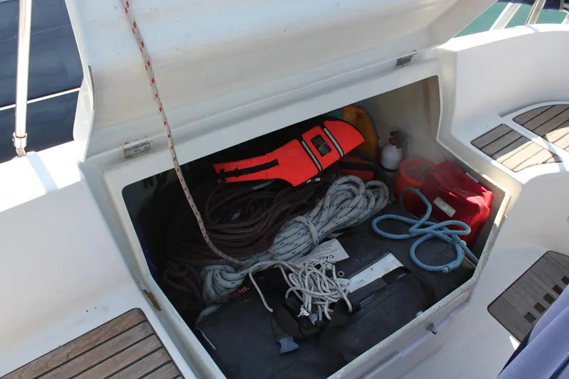 Hawaiian Passage Yacht Photos Pics Storage compartment on a 1997 Beneteau Oceanis 461 sailboat with ropes and safety gear.