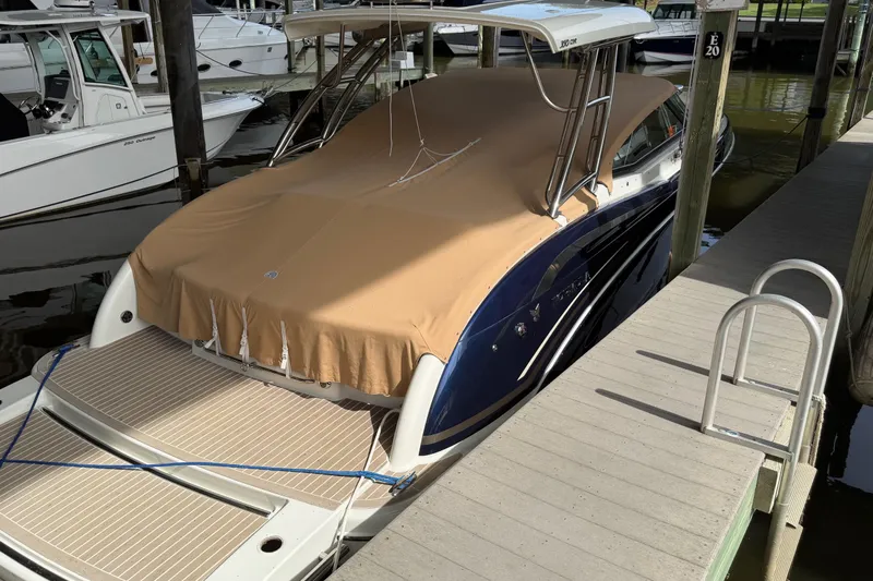  Yacht Photos Pics 2017 Formula 350 Crossover Bowrider docked with tan cover, marina setting.